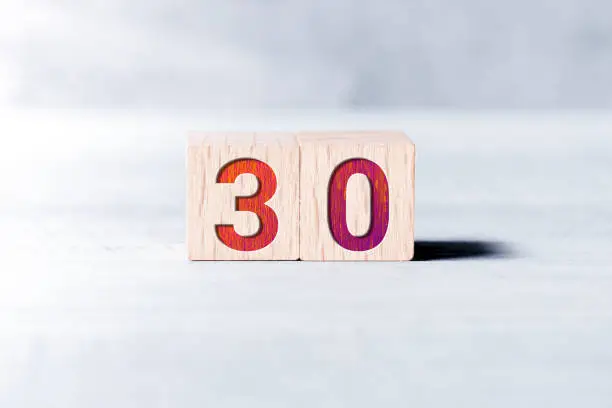 Number 30 Formed By Wooden Blocks On White Table