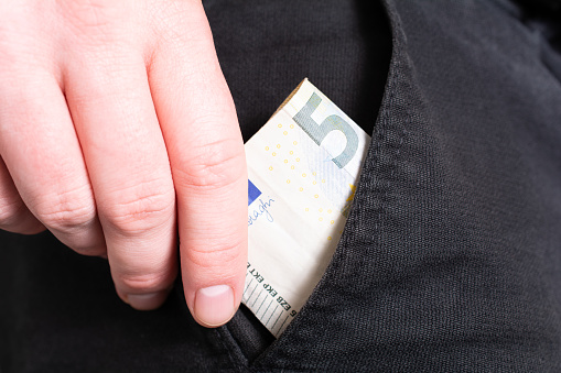 Male Hand Grabbing A 50 Euro Bill Out Of The Pocket Of Black Jeans Trouser- Poor Man Concept