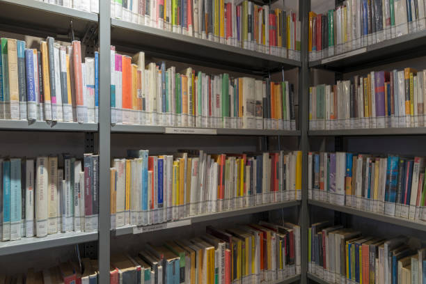 istock books on the shelf in a public library, bound, to be used as a background 1048942500
