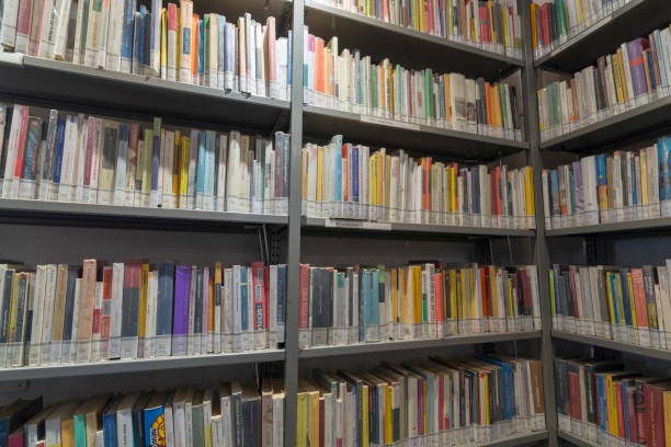 istock books on the shelf in a public library, bound, to be used as a background 1048945038