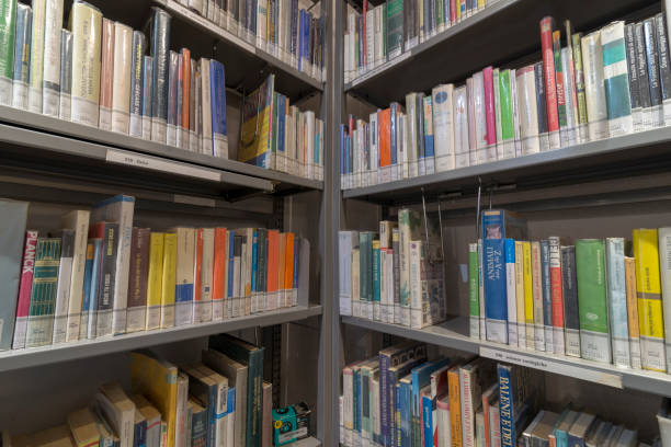 istock books on the shelf in a public library, bound, to be used as a background 1048945532