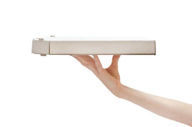 istock Woman's hand holding pizza box. Isolated on white. 1048946290