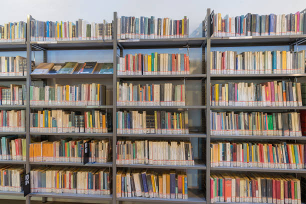 istock books on the shelf in a public library, bound, to be used as a background 1048950156