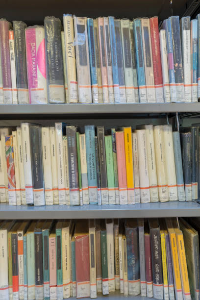 istock books on the shelf in a public library, bound, to be used as a background 1048950438