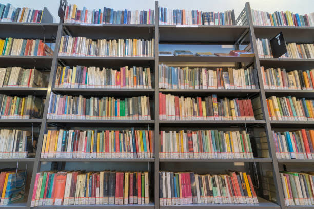 istock books on the shelf in a public library, bound, to be used as a background 1048951774