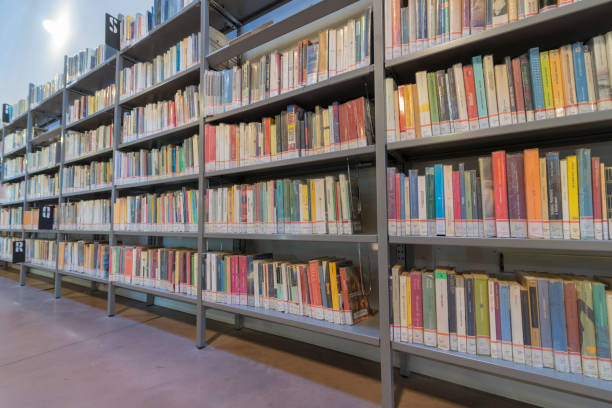 istock books on the shelf in a public library, bound, to be used as a background 1048951778