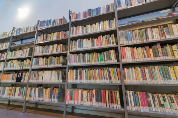 istock books on the shelf in a public library, bound, to be used as a background 1048951784