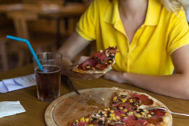 istock Woman holding pizza 1048954796