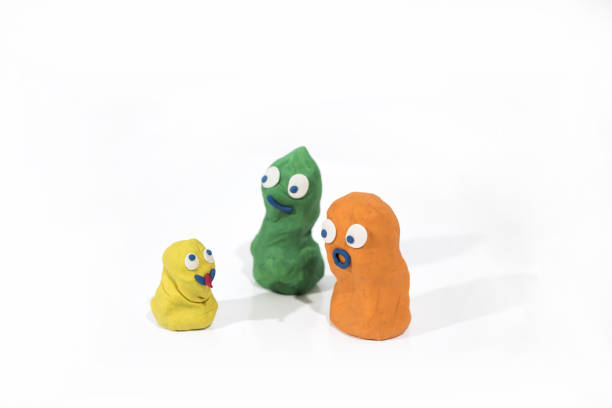 istock Funny figures made from Play Clay on white documents with glasses. 1048955754
