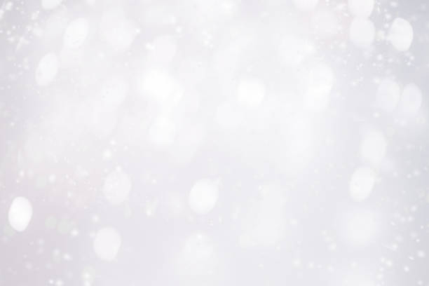 istock Silver  abstract bokeh background with snowflake and white glittering bokeh stars. A shiny holiday card. Glowing blurred lights