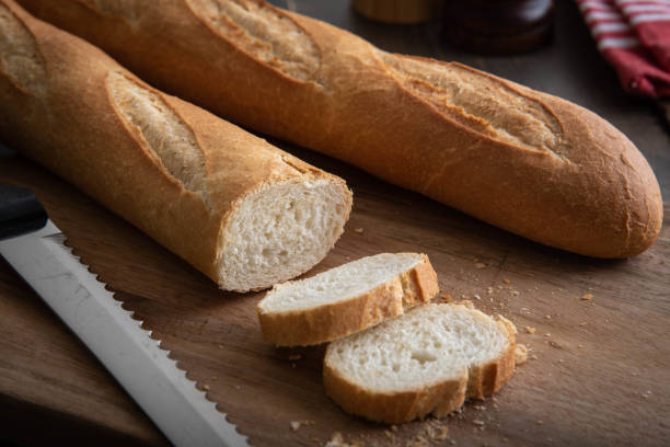 istock french baguette and bread knife 1048959376