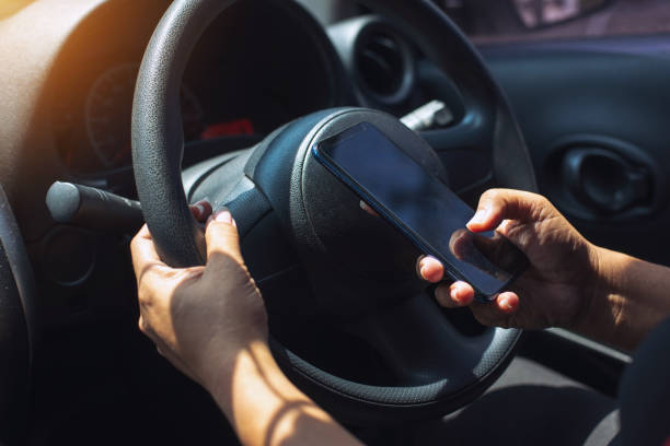 istock Selective focus,Business woman sitting in car and using her smartphone. Mockup image with female driver and phone screen,accident and insurance concept. 1048959458