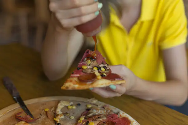 Photo of Eating pizza with ketchup