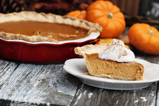 istock Homemade Pumpkin Pie Slice with Whiiped Cream 1048959638