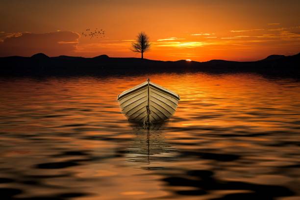 istock Fishing boat in the sea at red dawn 1048962244