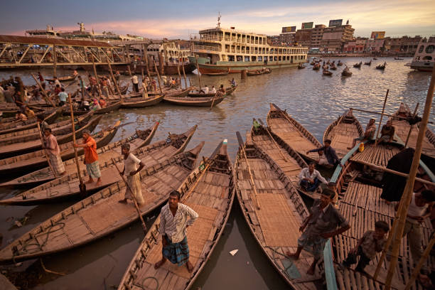 Dhaka's main transport port on the banks of the Buriganga River. Dhaka, Bangladesh, July 2009. Rowers waiting for customers at the launch terminal in Sadarghat. bangladesh photos stock pictures, royalty-free photos & images