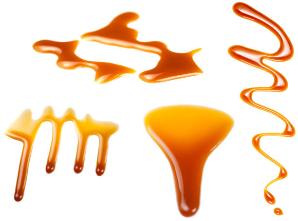 istock Caramel splashes isolated on white background. Spilled caramel sauce, toffee toppings 1048963072
