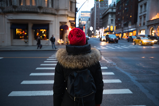 Woman waiting to cross the street in downtown Manhattan - New York City
