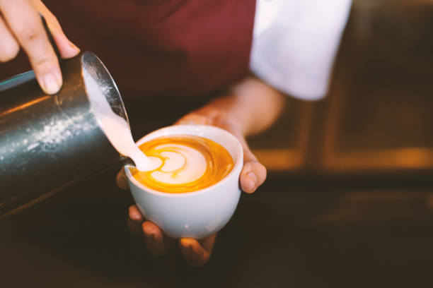 istock close up barista hands making latte art in cafe,copy space,warm retro tone. 1048966036