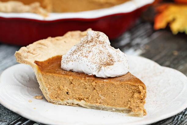 istock Delicious Pumpkin Pie Slice with Whiiped Cream 1048966894