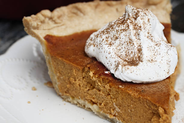 istock Delicious Pumpkin Pie Slice with Whiiped Cream 1048969572