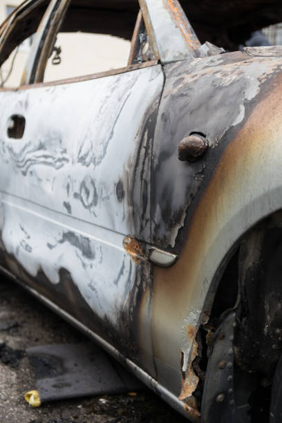 istock Burned out car after a car accident. Outside view. 1048971102