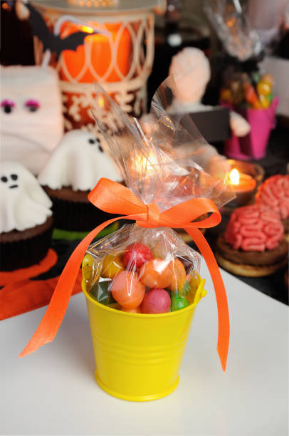 istock bucket filled with candy table among sweets for Halloween 1048975176