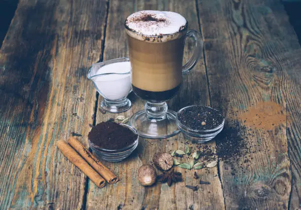 SPICE DIRTY CHAI LATTE. Masala chai and espresso. Autumn or winter warm spice coffee drink. Close up