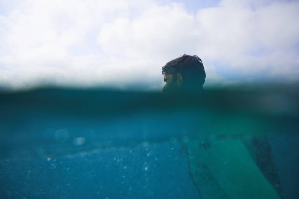 istock Half by half Sufer in the Ocean 1048994392