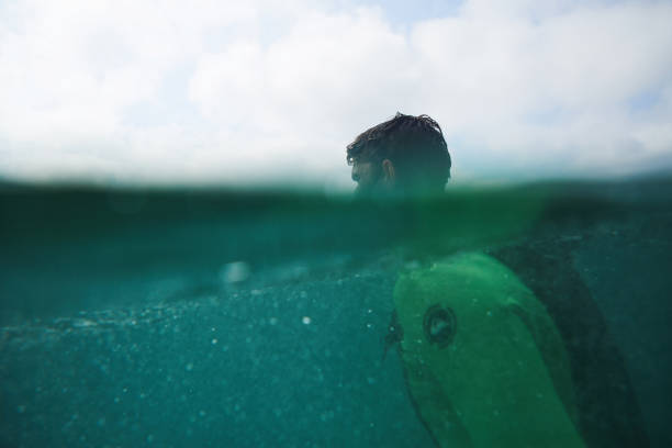 istock Half by half Sufer in the Ocean 1048994402
