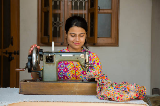 istock Indian Young Girl Sewing - Stock image 1048995476