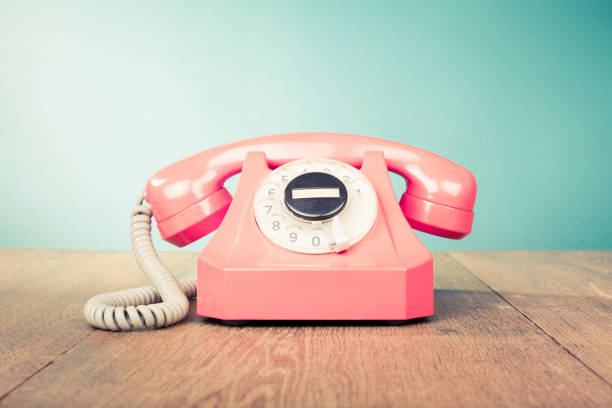 istock Retro telephone front mint green wall background. Old style filtered photo 1049000680