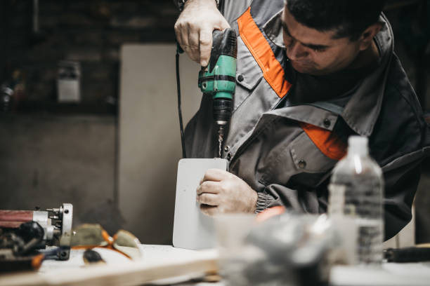 istock Mature man using drill on a piece of wood 1049007112