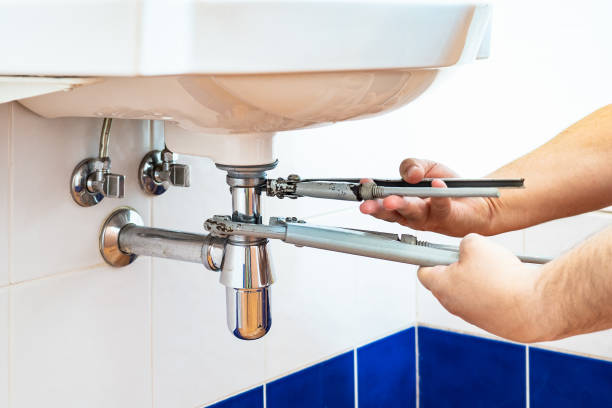 istock plumber unscrews sink siphon by two pipe-wrenches 1049007952
