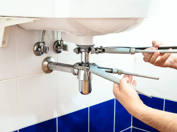 istock plumber repairing sink with two pipe-wrenches 1049007978