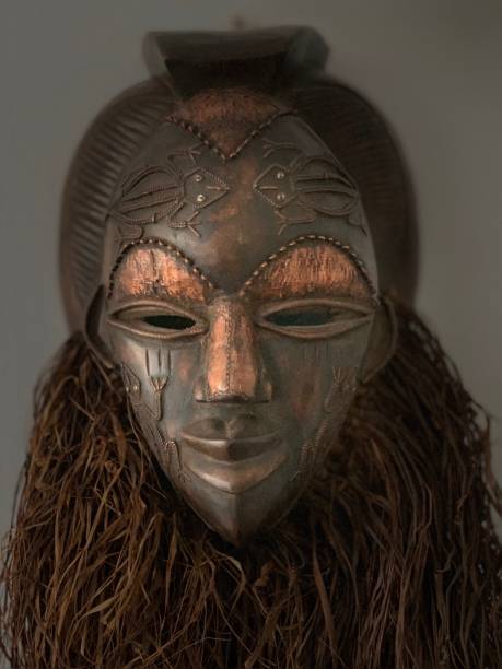 istock African mask isolated on dark background 1049012070