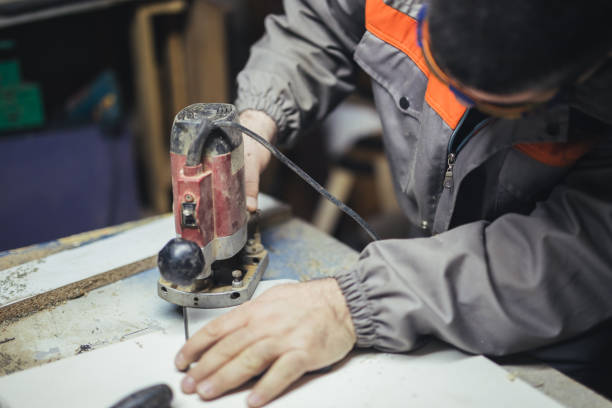 istock Middle-aged man working with wood router 1049012224