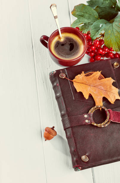 istock Cup coffee with book dry oaken leaf 1049026436