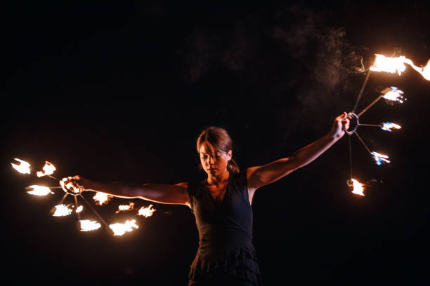 istock Lovely girl spinning fire at night 1049029208