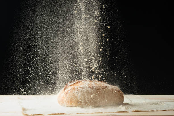 istock Fresh bread on the table close up in a scattering of flour. Fresh bread on the kitchen table. A healthy diet and a traditional bakery concept. 1049033084