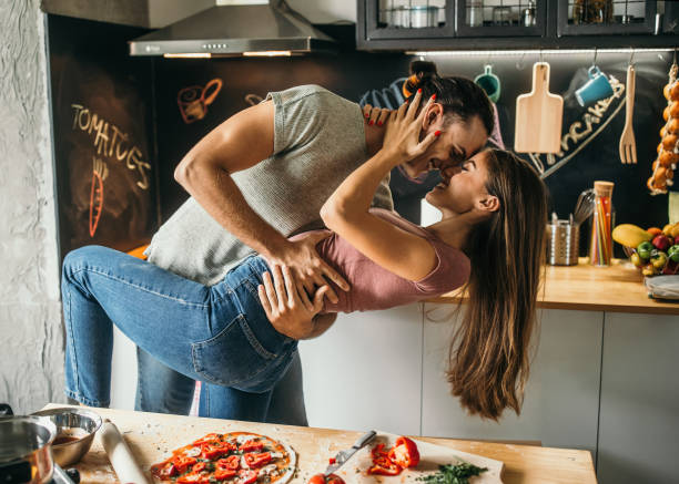istock Affectionate couple looking happy at home 1049039812