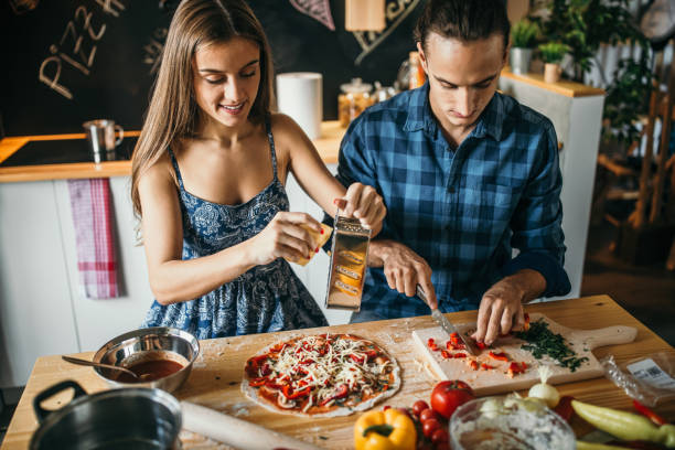 istock Grating the cheese on the pizza 1049040194