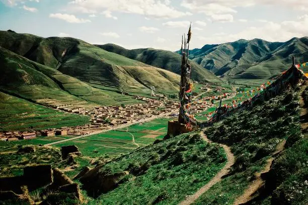 Photo of mountains and the valley around the tibetan village and temple