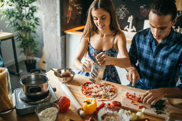 istock Young woman grating the cheese on the pizza 1049043198