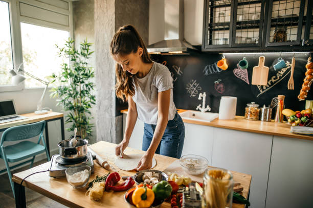 istock Young woman preparing pizza 1049043372