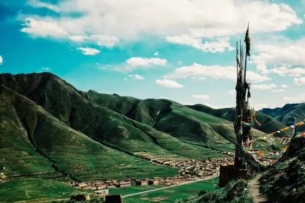 Photo of mountains and the valley around the tibetan village and temple