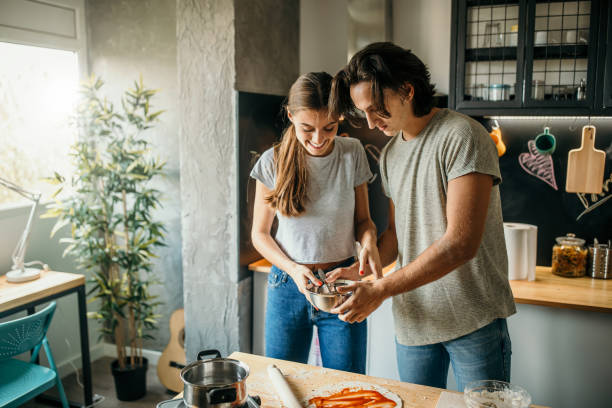 istock Young couple preparing pizza at home 1049043460