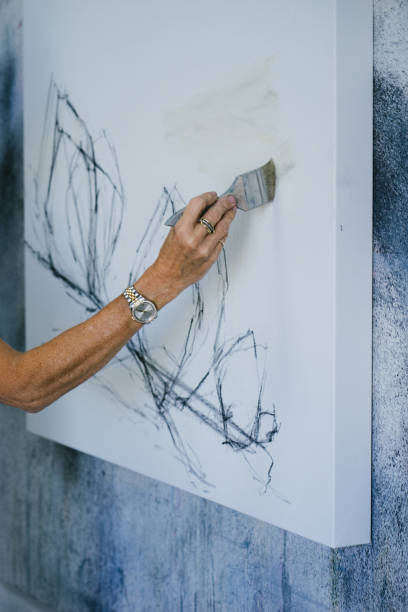 istock Woman painting canvas in art studio 1049053542