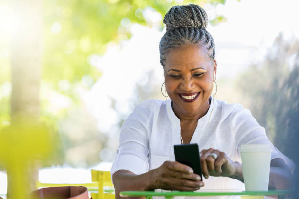 istock Active senior woman uses mobile app 1049053754