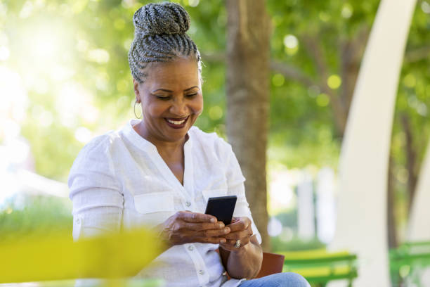 istock Smiling African American uses smartphone 1049053776